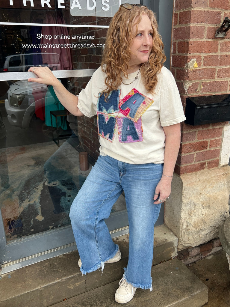 On a person standing in front of the shop.  MAMA kantha and denim comfort color tee - Main Street Threads